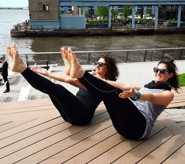 Mom and I in boat pose on the pier