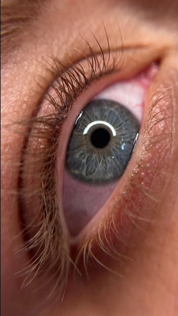 Healed lash enhancement tattoo showing defined eyes without visible liner.