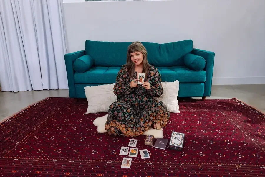 Sarah Jane Chapman holding a tarot card, Embodied Tarot Practitioner Training in Nashville