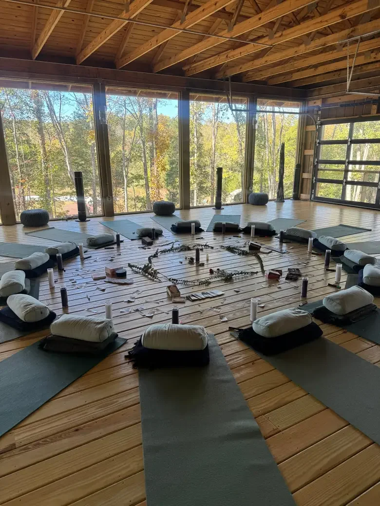 Yoga studio at Bask Retreat Center in Centerville, TN with mats and bolsters arranged in a circle