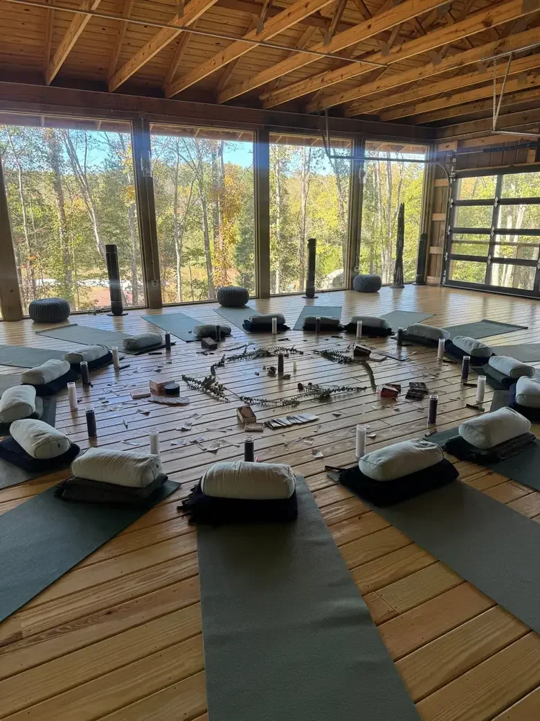 Yoga studio at Bask Retreat Center in Centerville, TN with mats and bolsters arranged in a circle