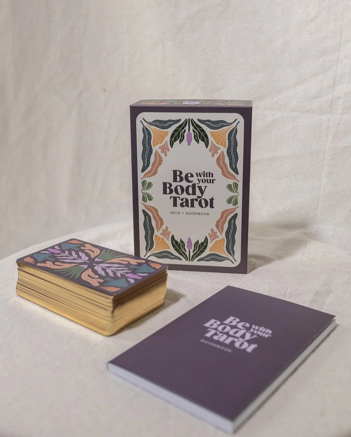Tarot card set including a deck, guidebook, and decorative box.