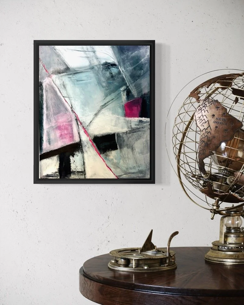 Gera Dunachie abstract painting "False Warmth" in a black floater frame, mounted on a raw cement wall.