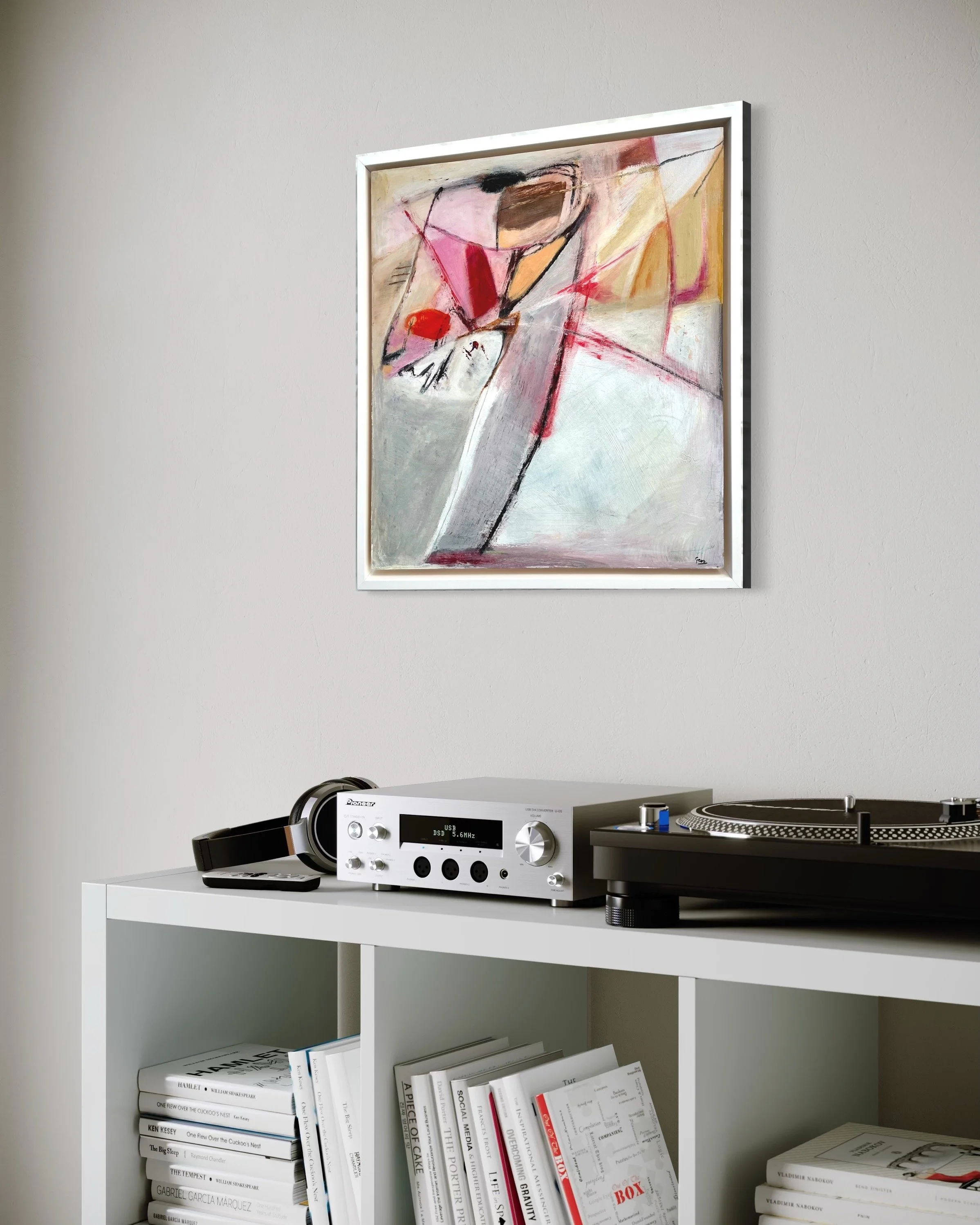 New Memories’ by Gera Dunachie displayed above a turntable and console in a minimalist interior; abstract composition of soft greys, pinks, reds, and warm neutrals with dynamic graphite lines and layered textures