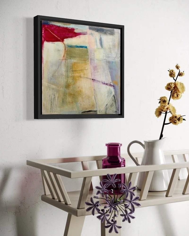 Controlled Rage, abstract painting by Gera Dunachie in a black frame, displayed above a white wall-mounted shelf with ceramic vessels and flowers in a pale interior.