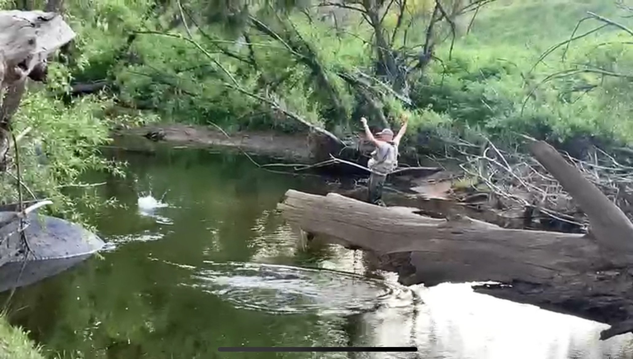 Man in full fishing waders flying fishing ion the river