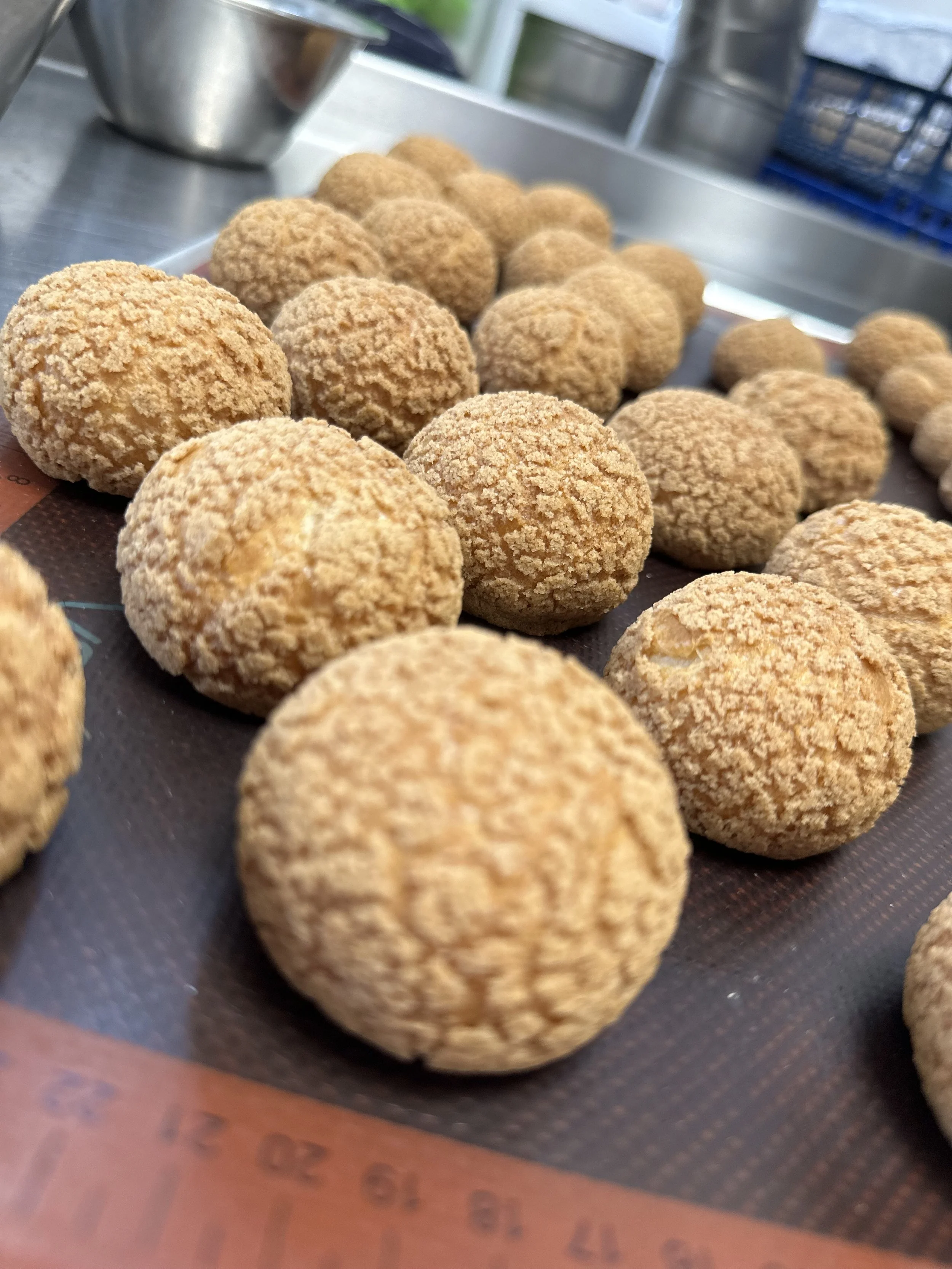 Close-up of rchoux bun for afternoon tea, on a baking tray.