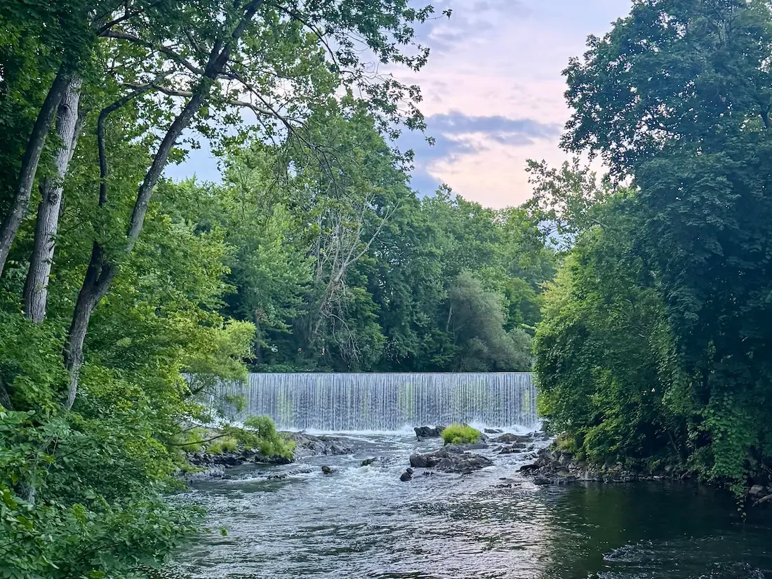 pretty waterfall surrounded by trees and foliage in beacon new york