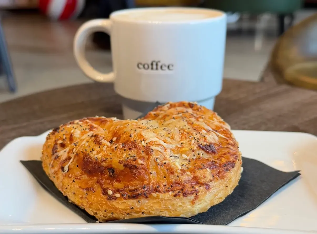 balthazar pasty on a plate with a white coffee mug on a table