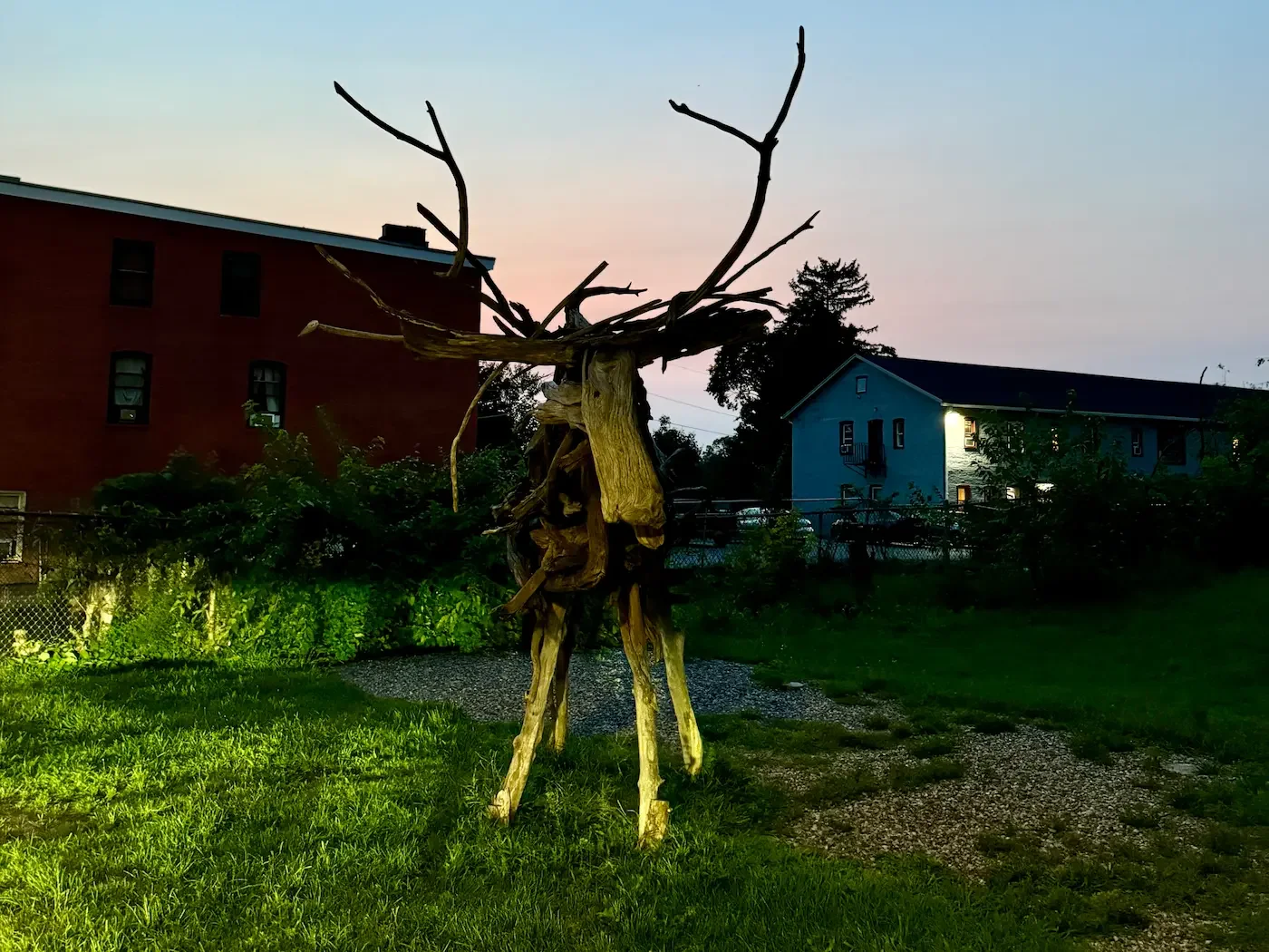 wooden moose sculpture on grassy area