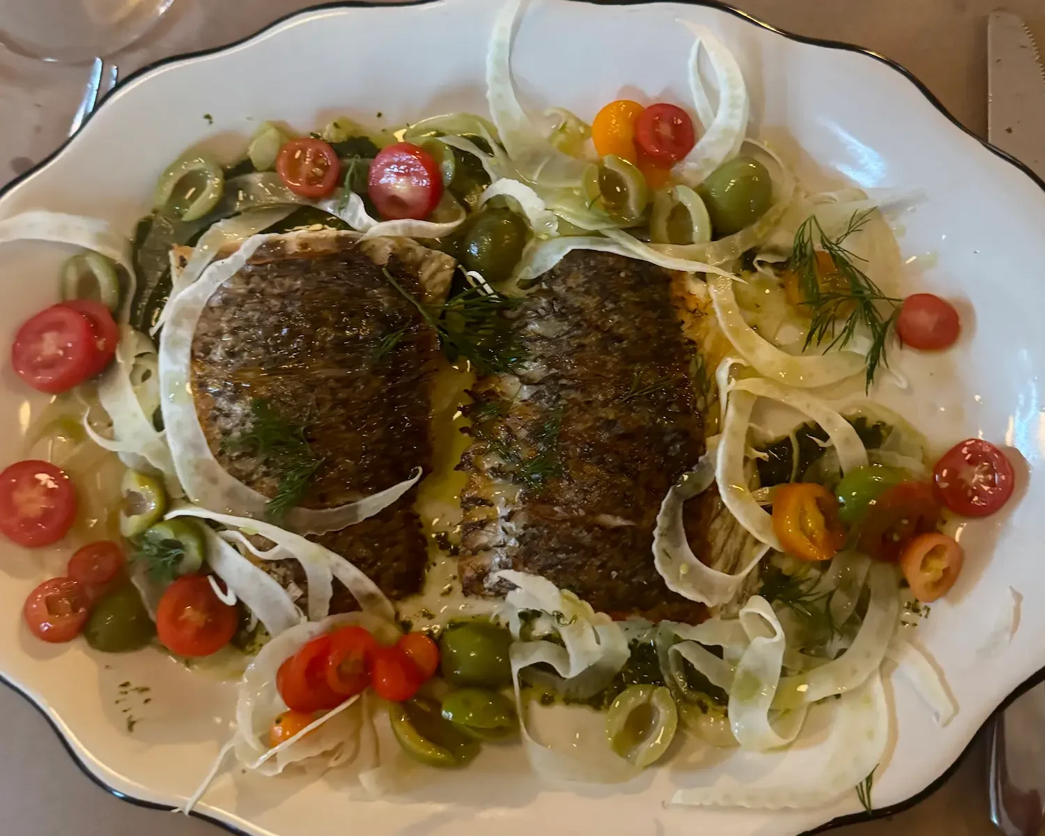 restaurant dish of fish with vegetables