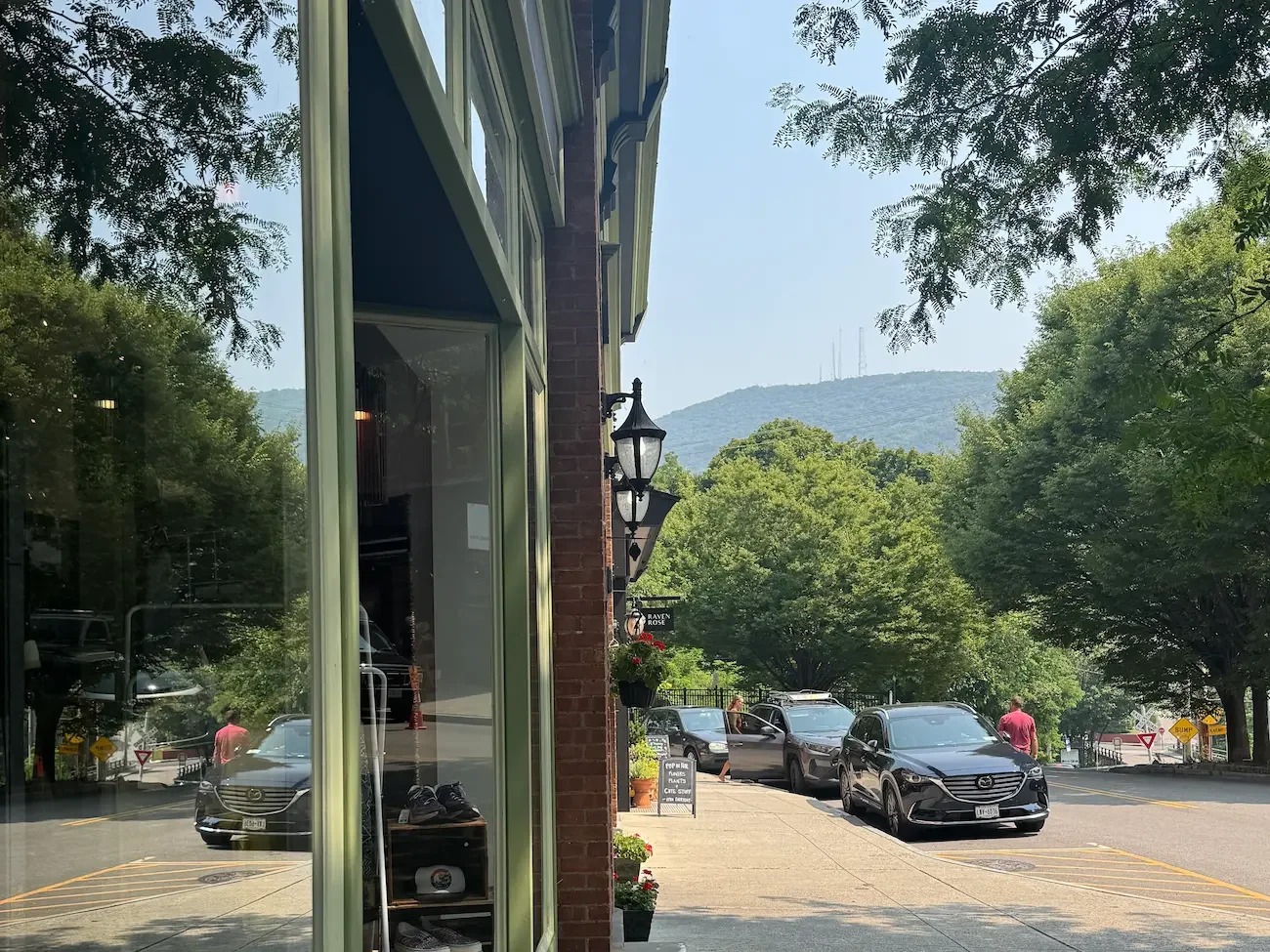 side view of shop fronts and a sidewalk leading to mount beacon in background