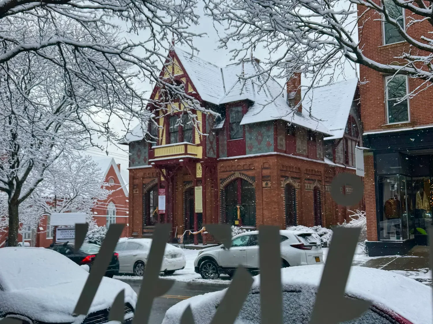 Victorian gothic building seen from the interior of a shop window