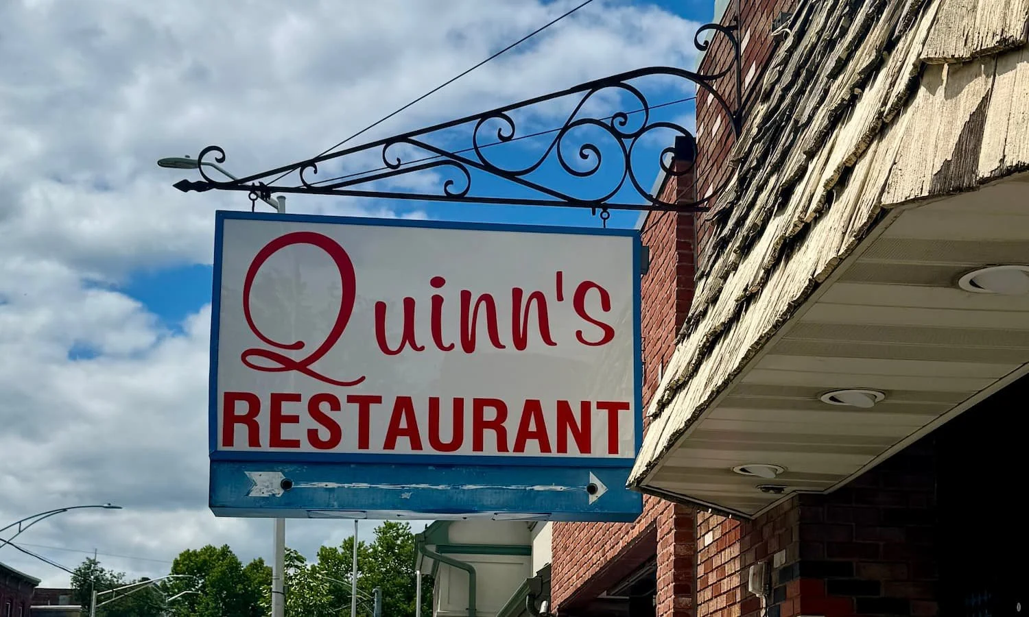 vintage quinns restaurant sign on a street
