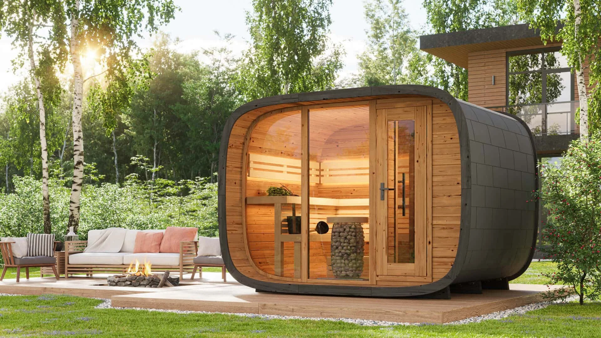 A modern outdoor sauna with a wooden interior and curved exterior, situated in a lush backyard with a stone fire pit, patio seating, and greenery, bathed in sunlight.