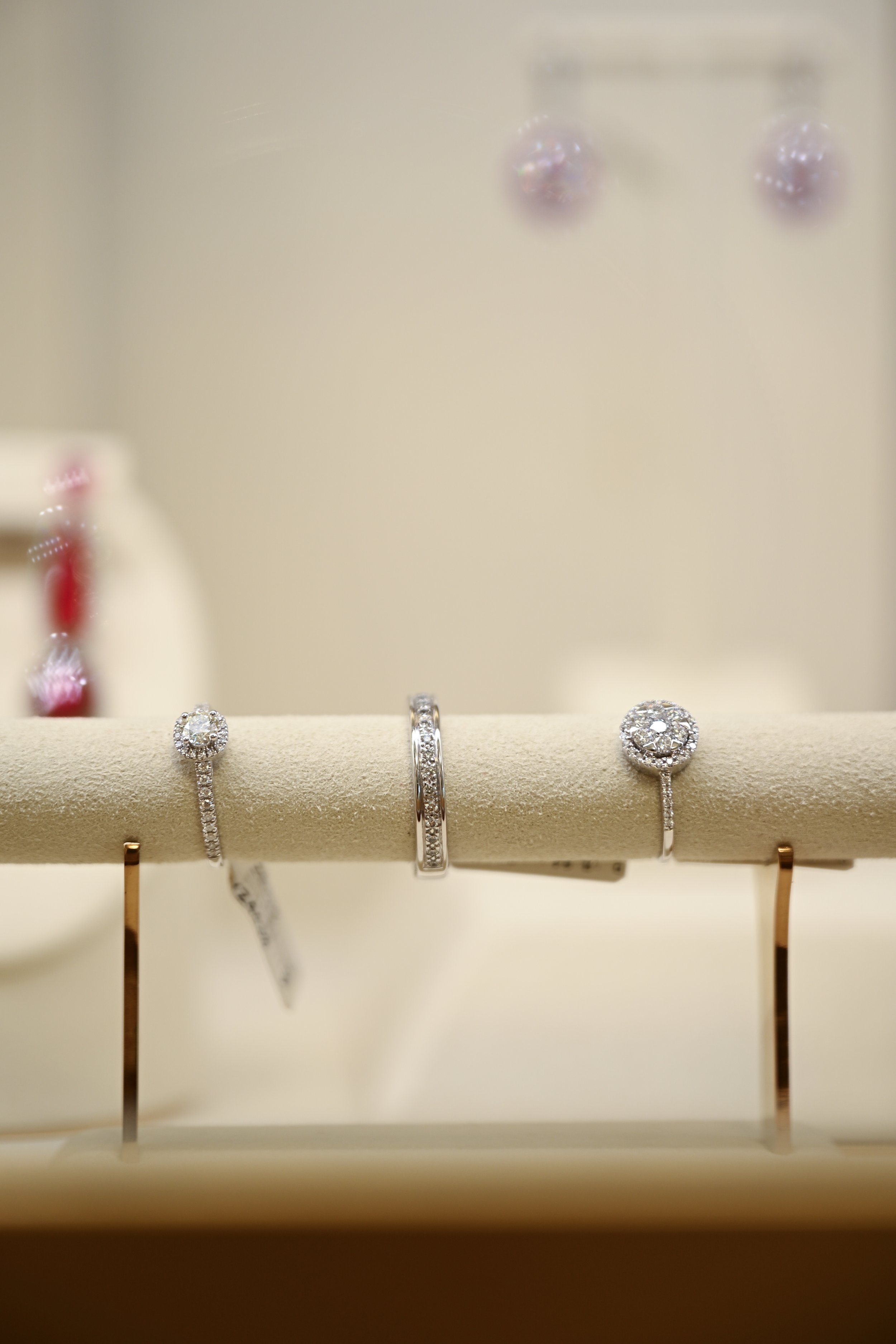 Display of multiple diamond rings from Diamotto on a jewelry stand.