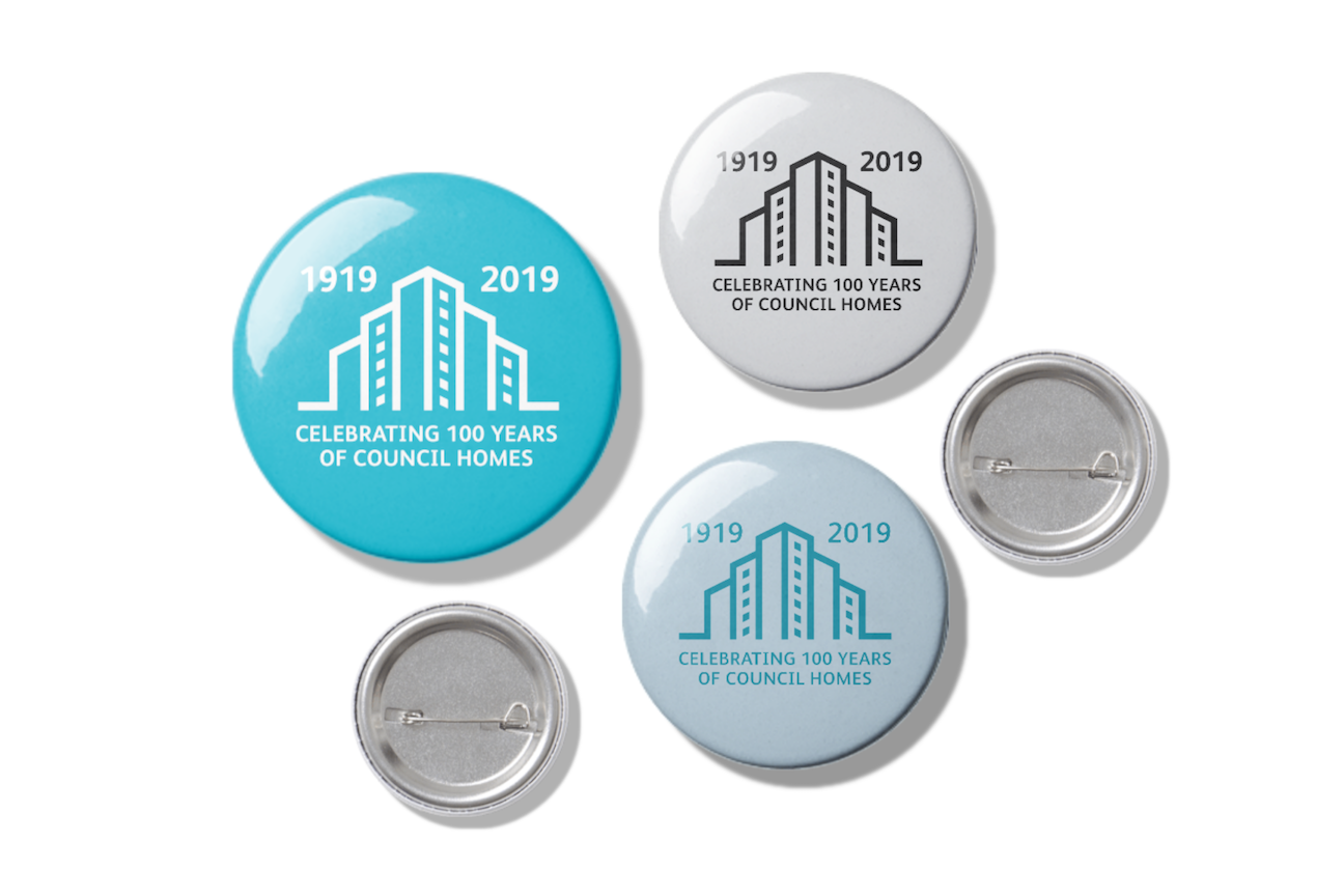 100 years_pin-button-mockup-scene.png