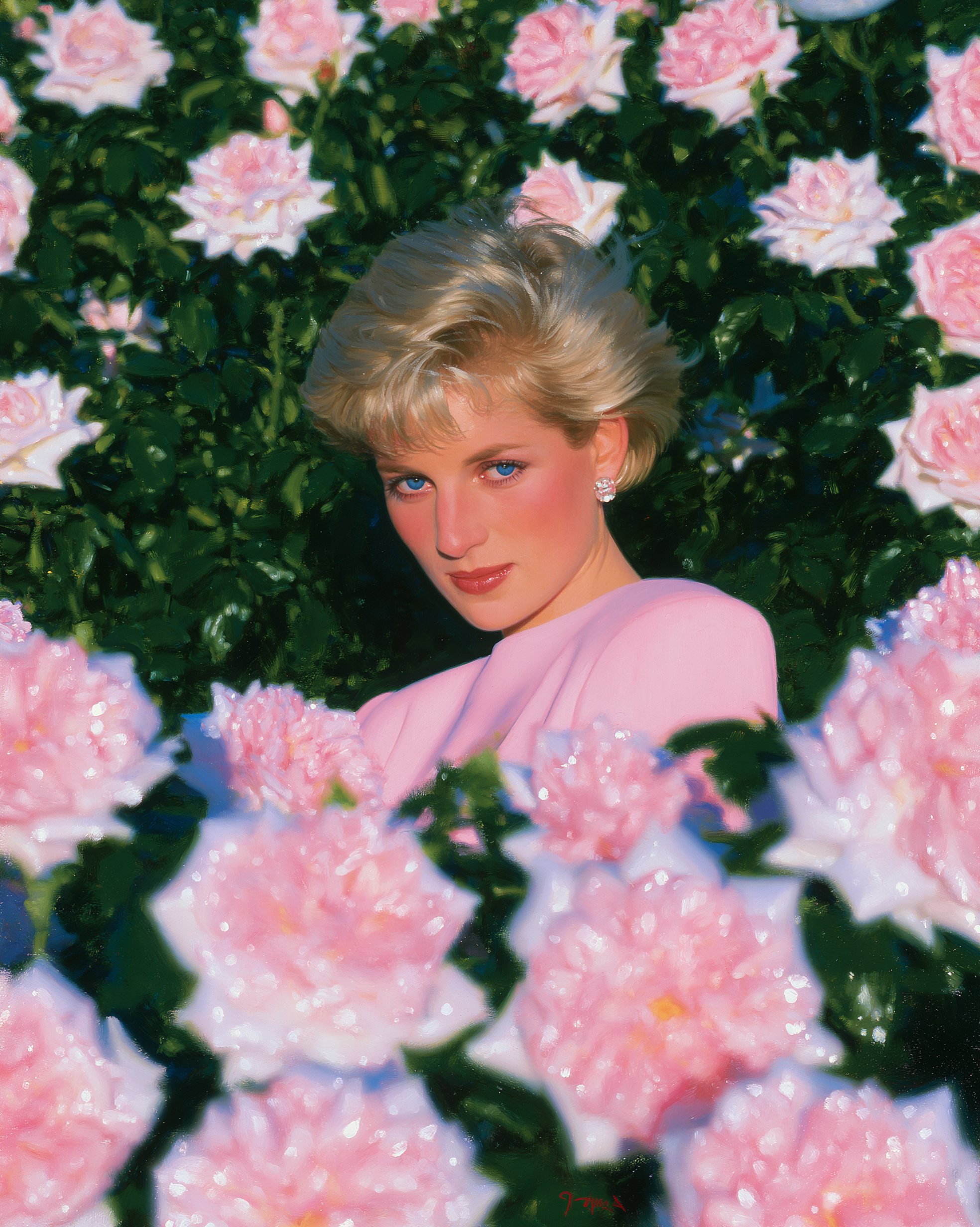 Portrait of a young woman with blonde hair and blue eyes, wearing pearl earrings, a pearl necklace, and a royal blue dress, standing outdoors among blooming flowers and green foliage.
