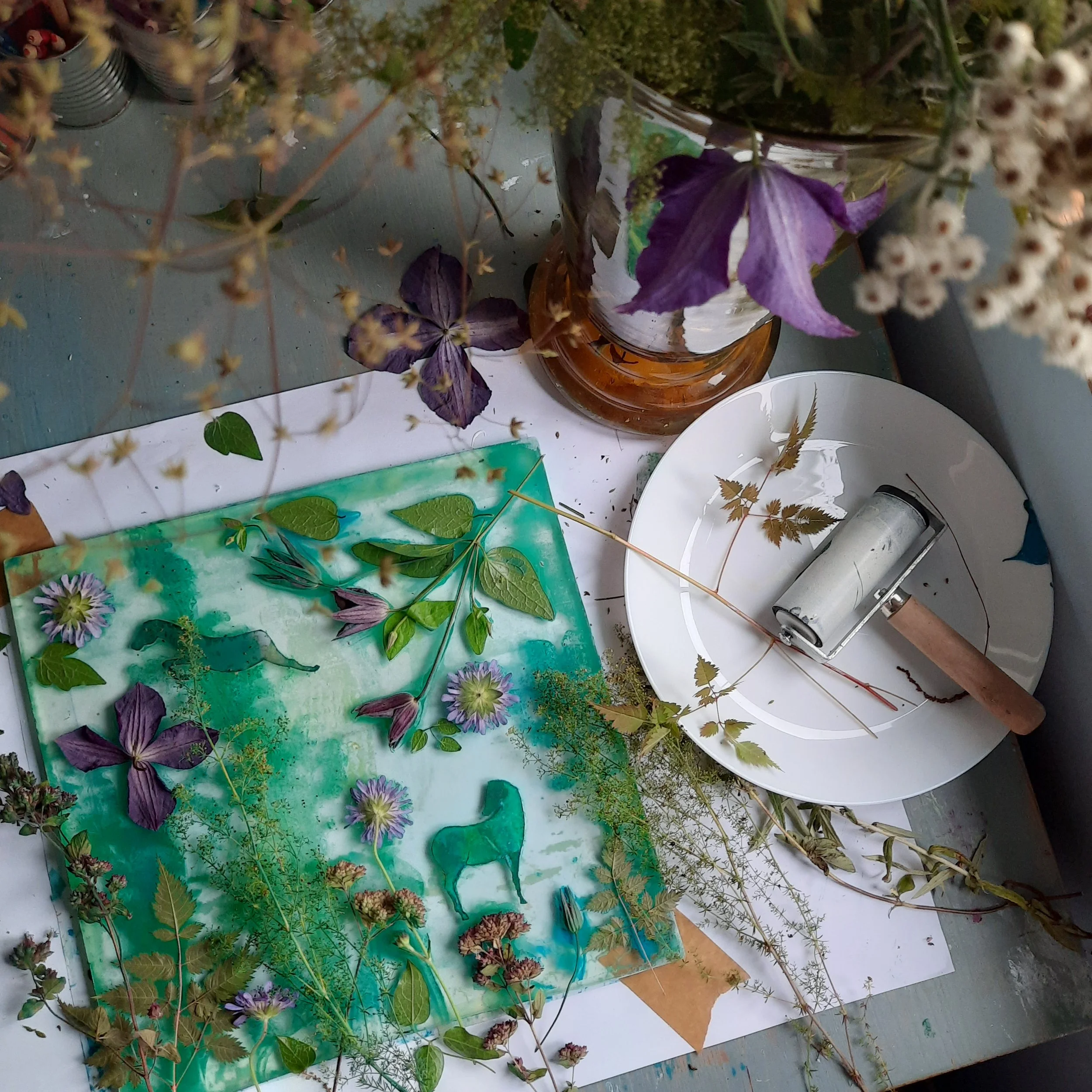 gelplate and brayer with botanical elements on desktop