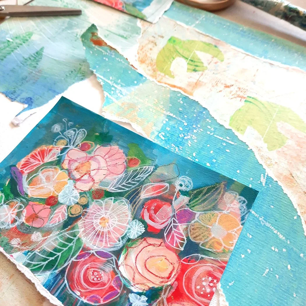 A colorful mixed media artwork with floral and abstract patterns, including torn paper edges, layered on a textured background with shades of blue, green, and beige.
