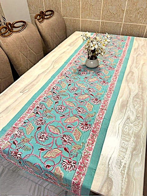 Lotus design on a turquoise base table runner