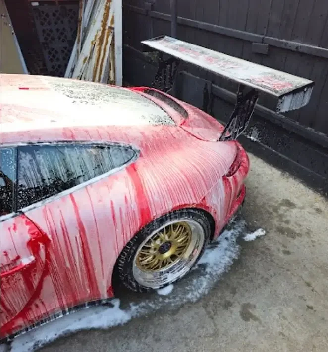Porsche+red+with+gold+rims.webp
