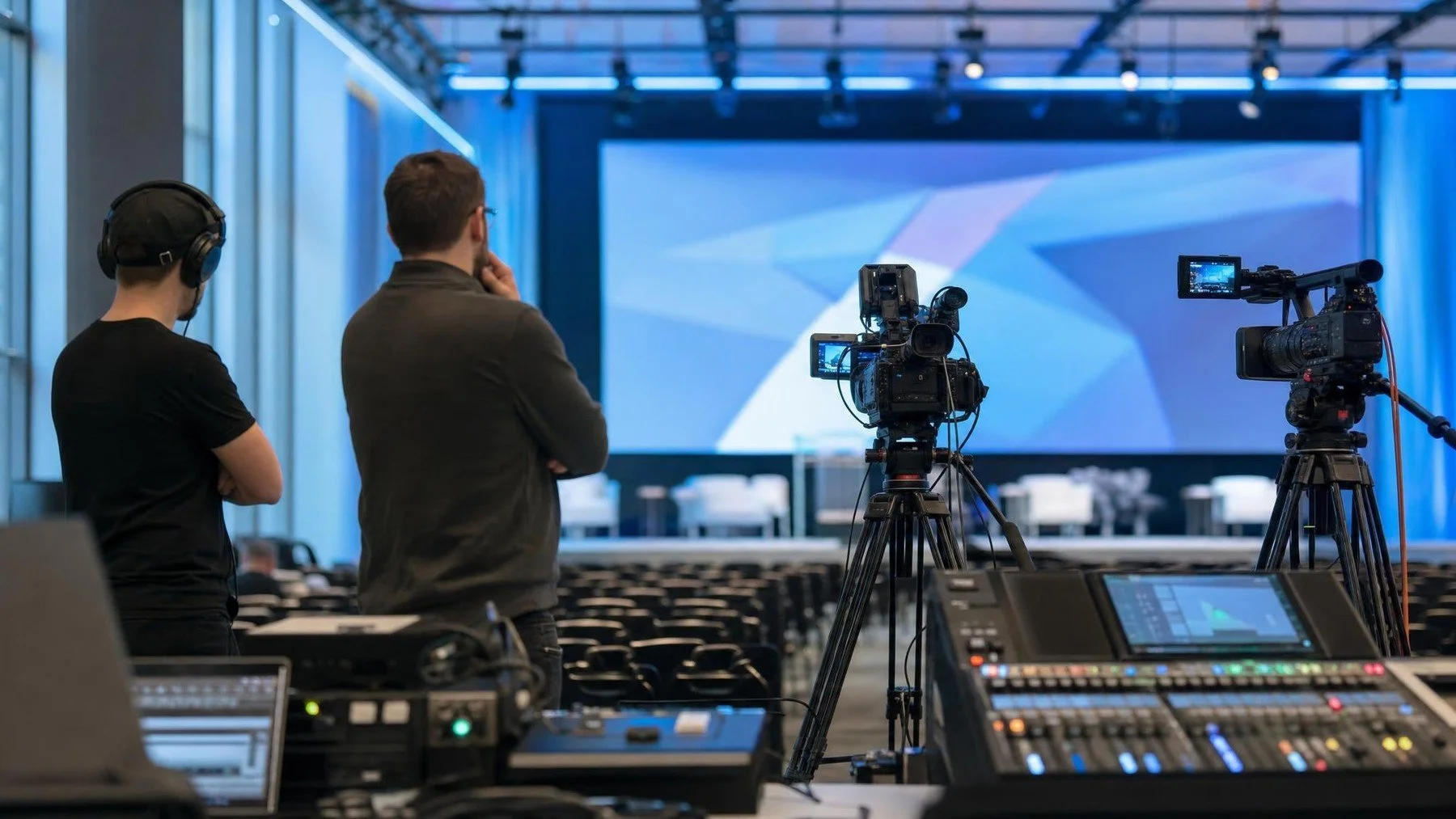 Camera crew preparing a multi-camera keynote recording with venue AV equipment