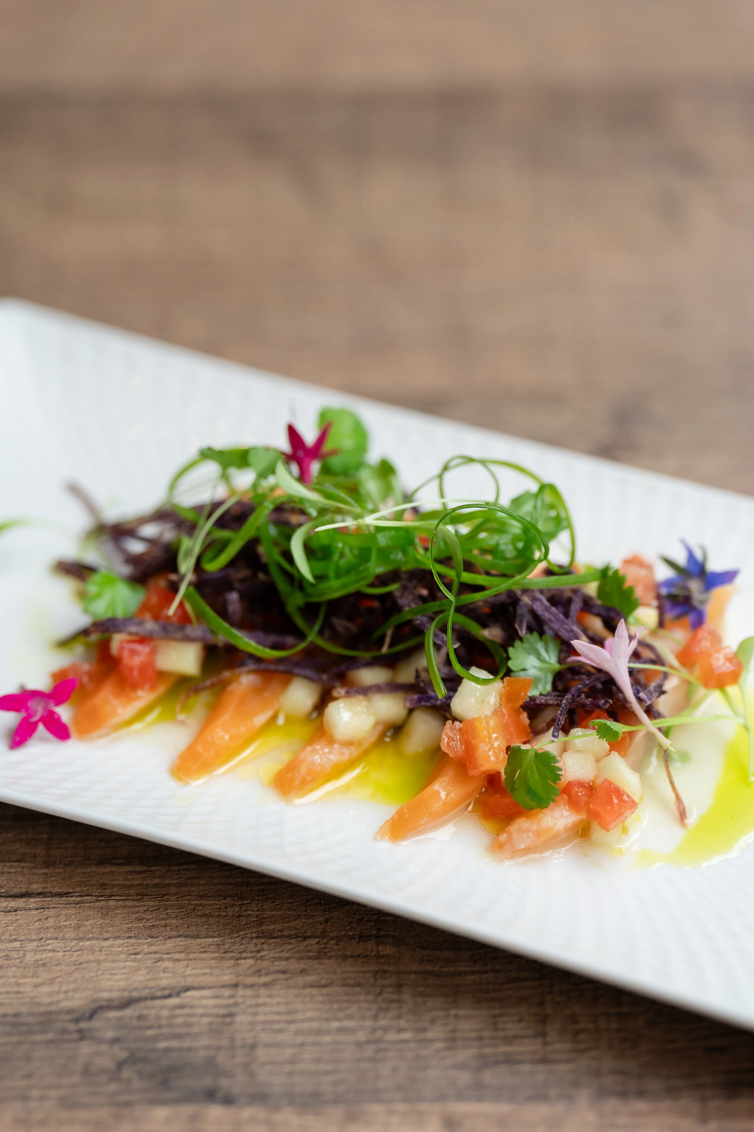 Beautifully plated vegetable salad with greens, diced tomatoes, and colorful garnishes served at Gutsy – The Hive event.