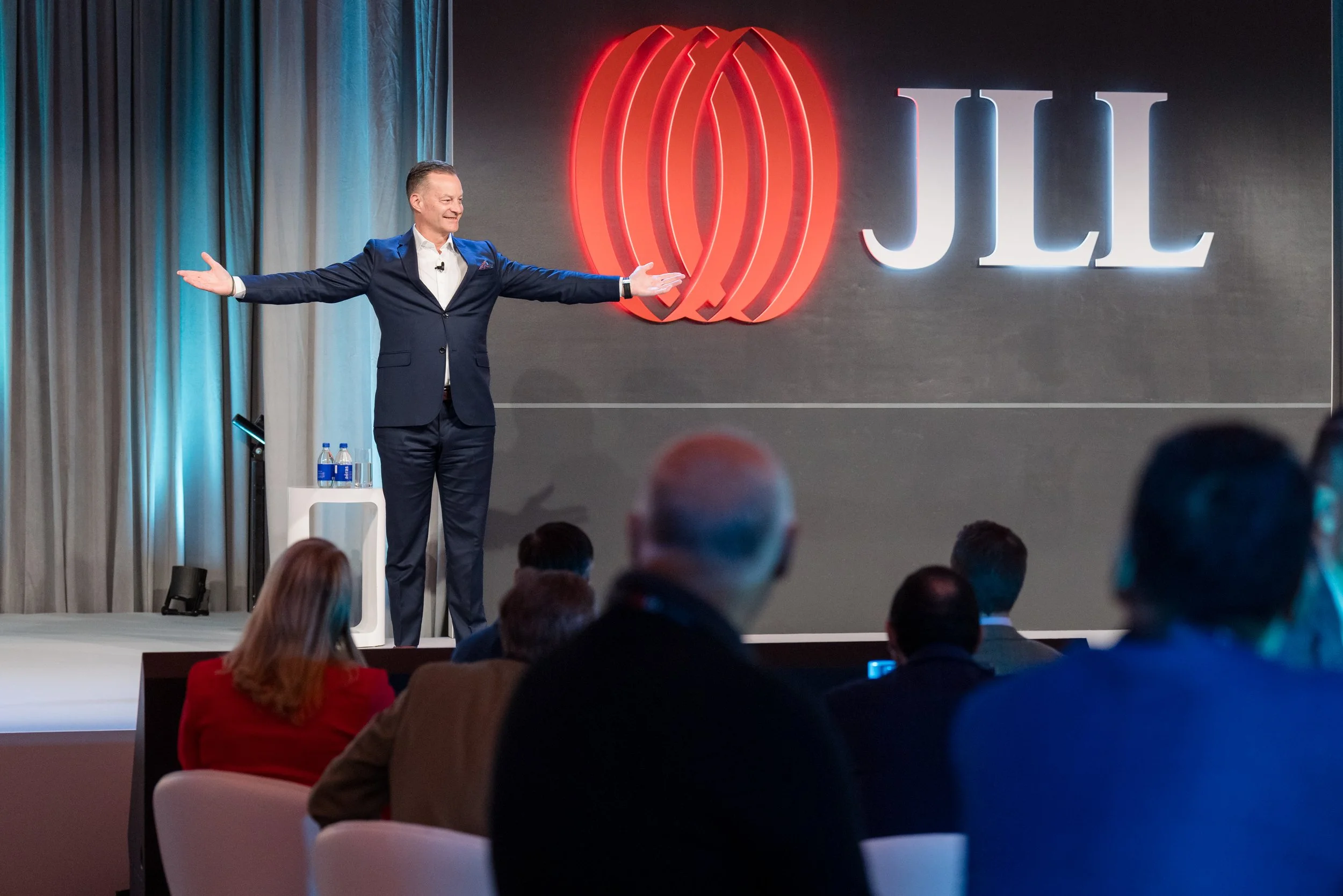 Keynote speaker engaging the audience at the JLL Global Leadership Meeting 2024 at Park Hyatt Toronto.