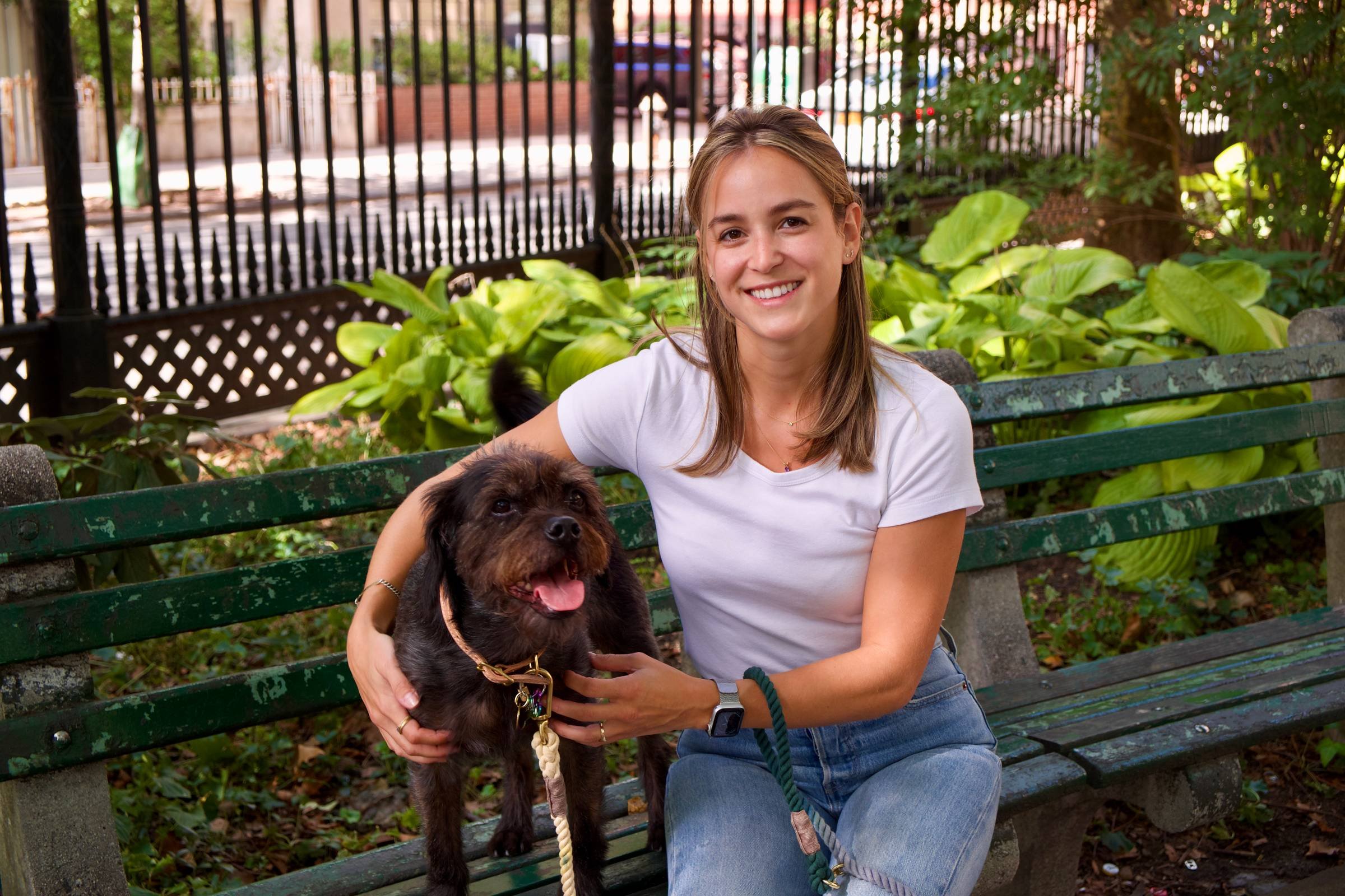 Maddie sitting on bench with dog