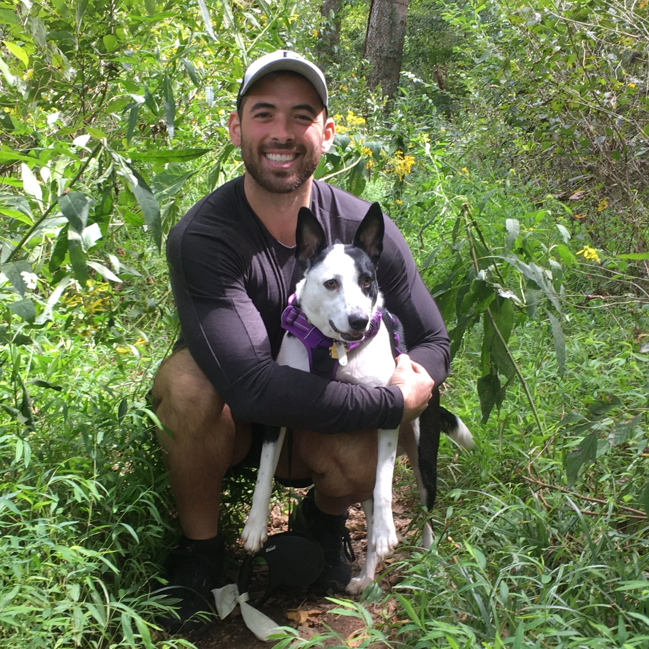 Photo of Sean Valle, the founder and CEO of Cotl, with his black and white dog, Domino.
