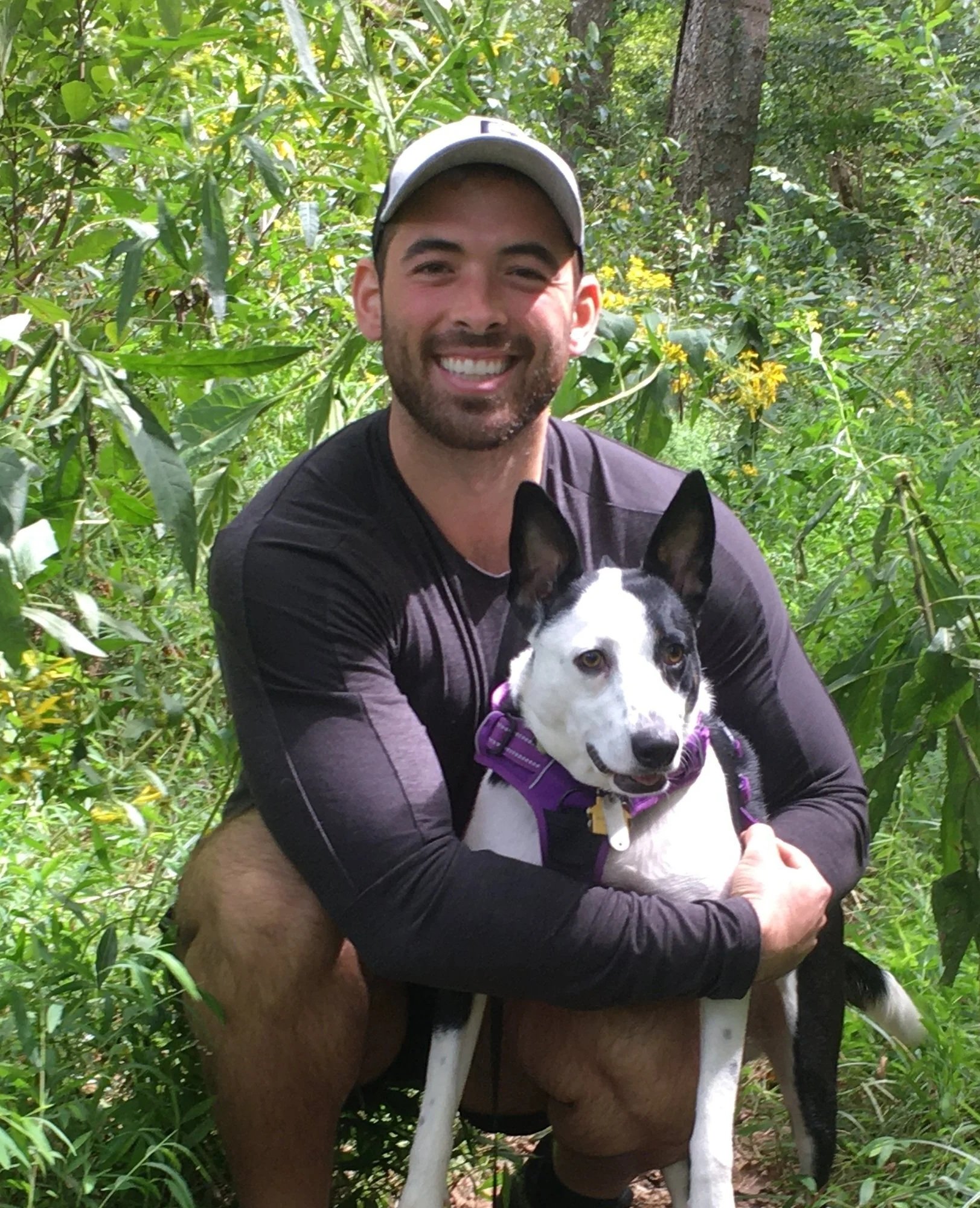 Photo of Sean Valle, the founder and CEO of Cotl, with his black and white dog, Domino.
