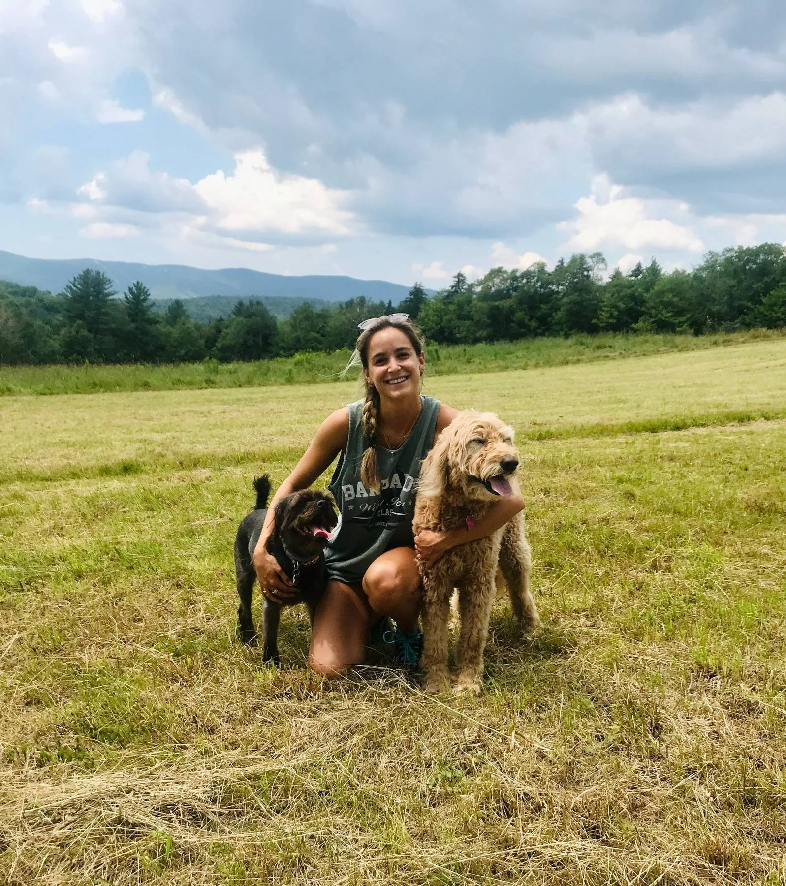 Maddie in field with two dogs