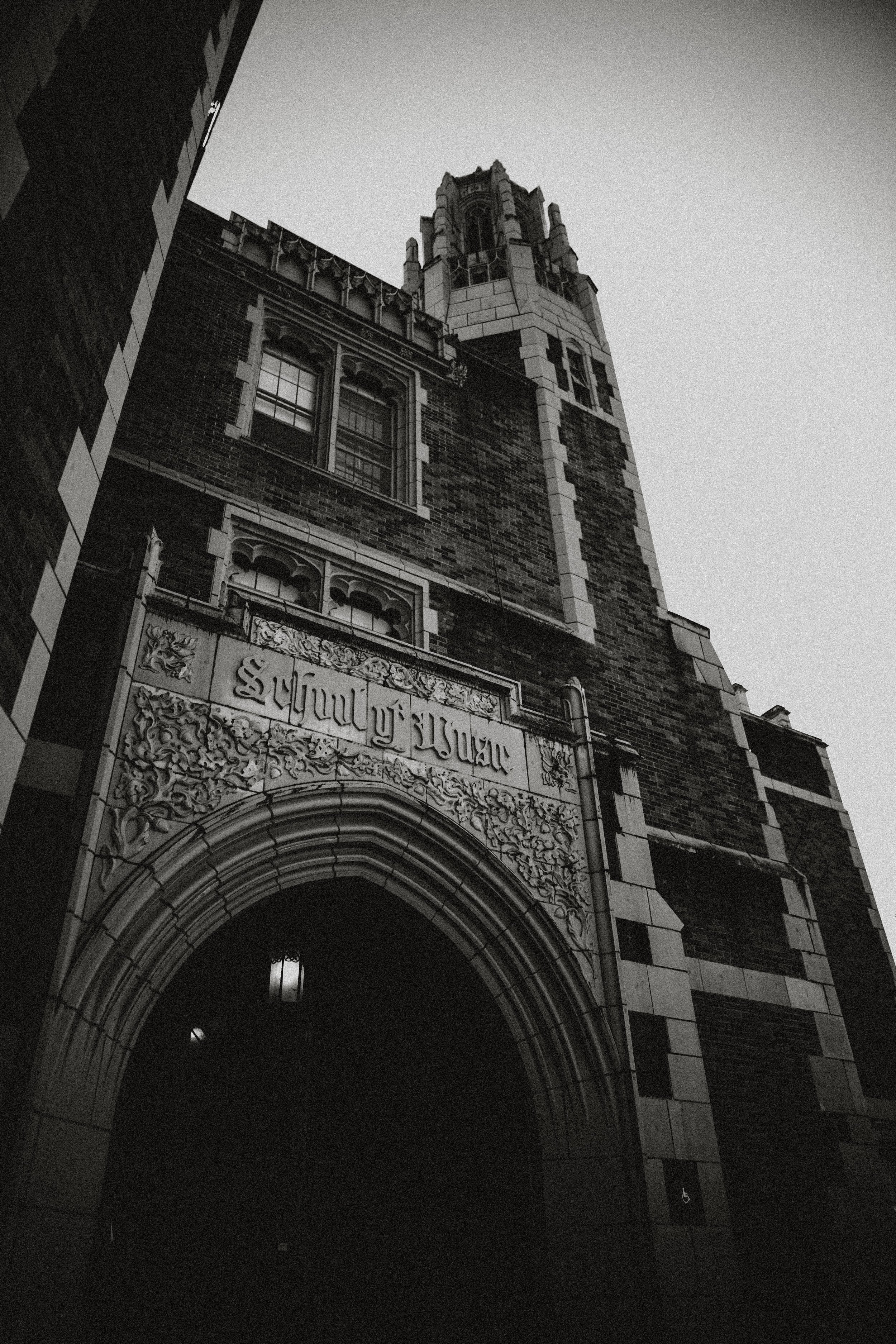 dramatic black and white gothic building. school of music on the front in old gothic font.