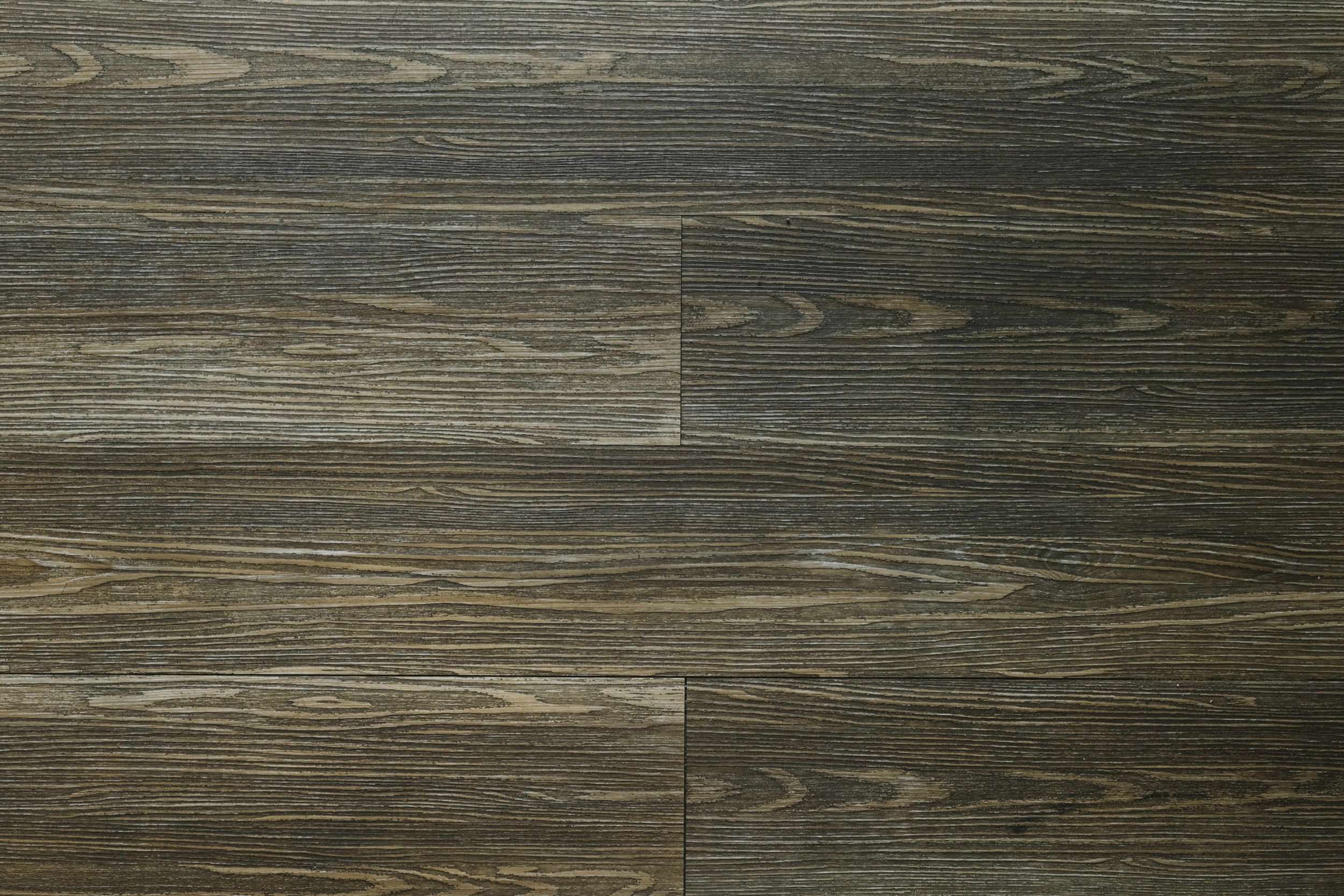 Close-up view of a dark wooden surface with visible grain lines and textured appearance.