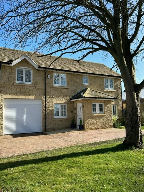 View of front of house with garage door to the left.