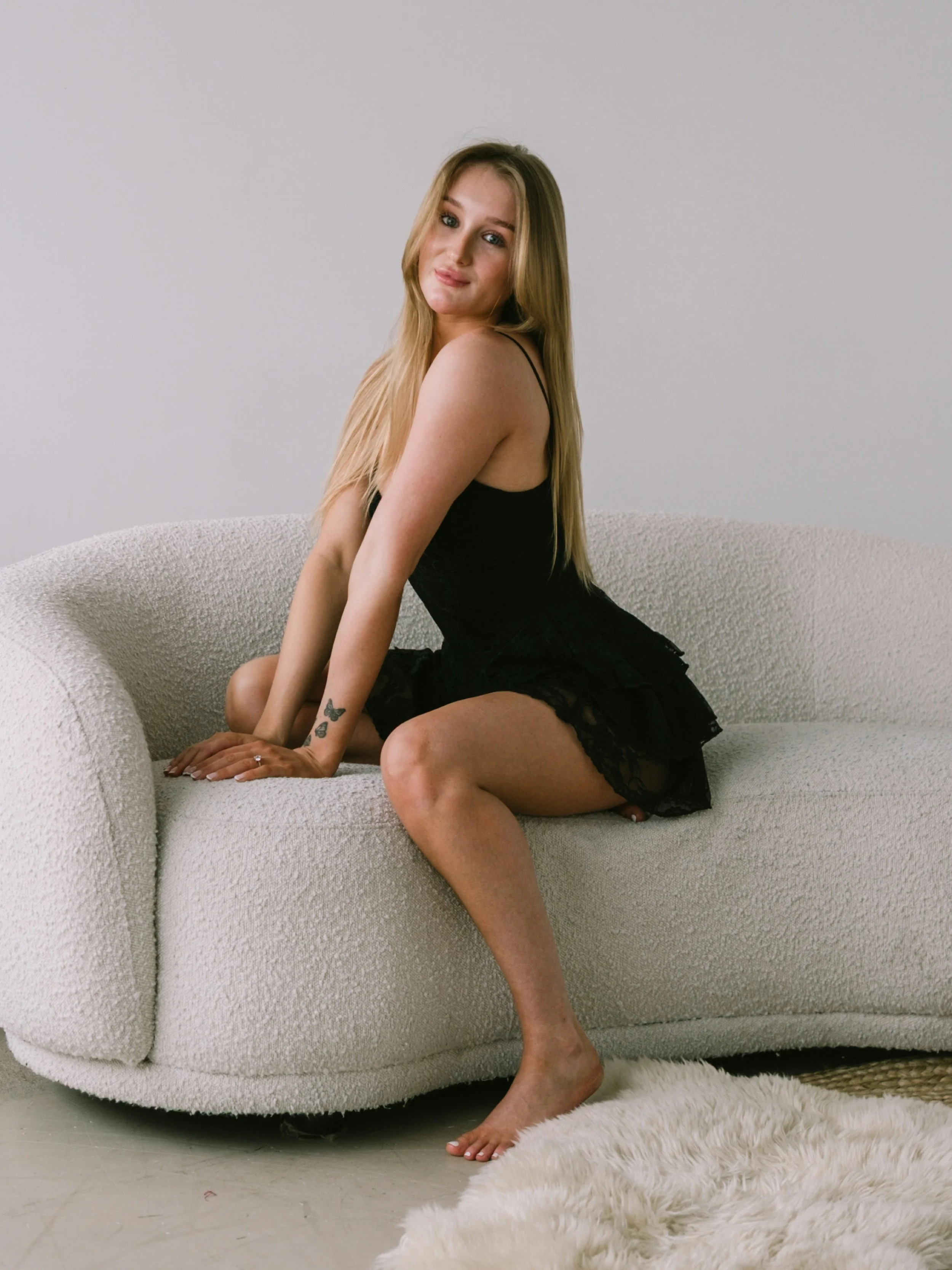 girl in a black dress with a natural tan
