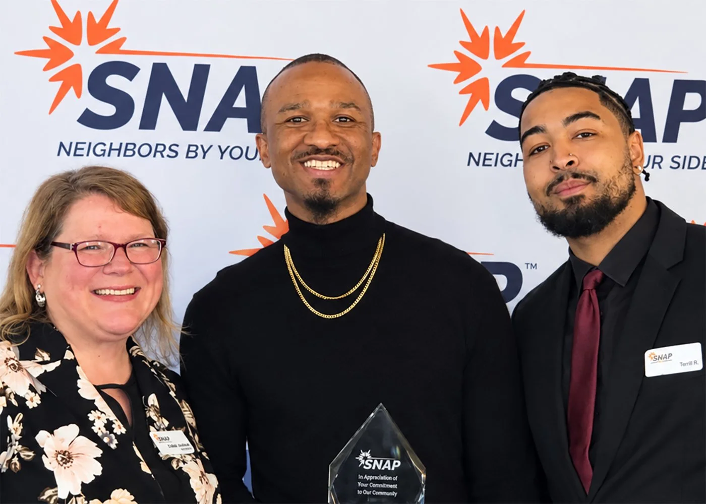 Derrick Jenkins receiving the Justice Award at the SNAP partnership appreciation event. Pictured from left to right: Amber Johnson (CEO of SNAP), Derrick Jenkins (Navigator at Carl Maxey Center, & Tsai Ross (Outreach Specialist at SNAP). 