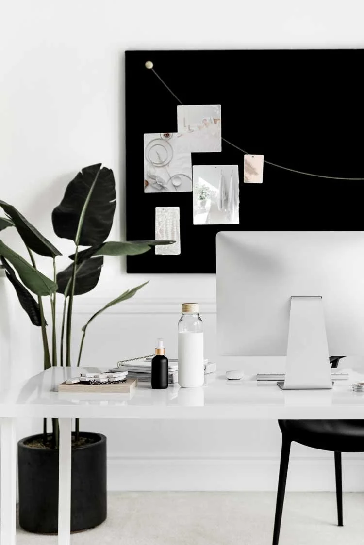 Creative studio workstation with a brand moodboard and computer, illustrating the essentials of bespoke branding and web design for heart-centered businesses.