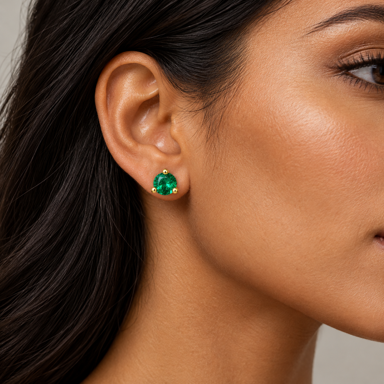 Styling concept of an adult model wearing a yellow-colour Verdant Round green-stone stud.
