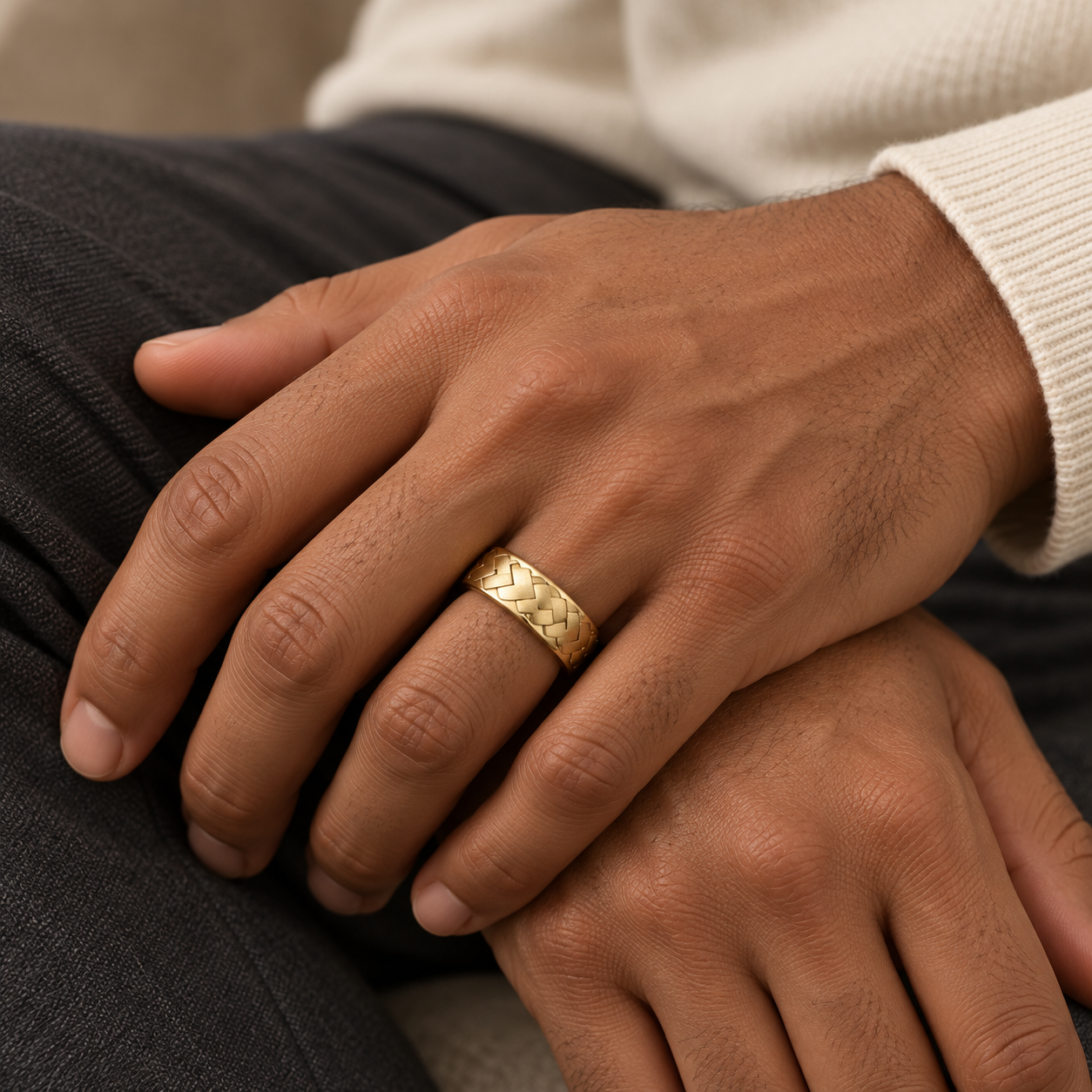 Yellow gold Interlace Band worn on a hand.