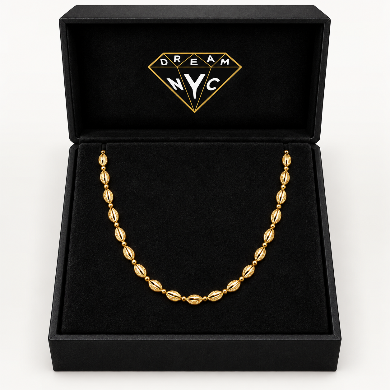 Golden Cowrie Necklace displayed in a black DREAM NYC jewelry box, packaging concept.