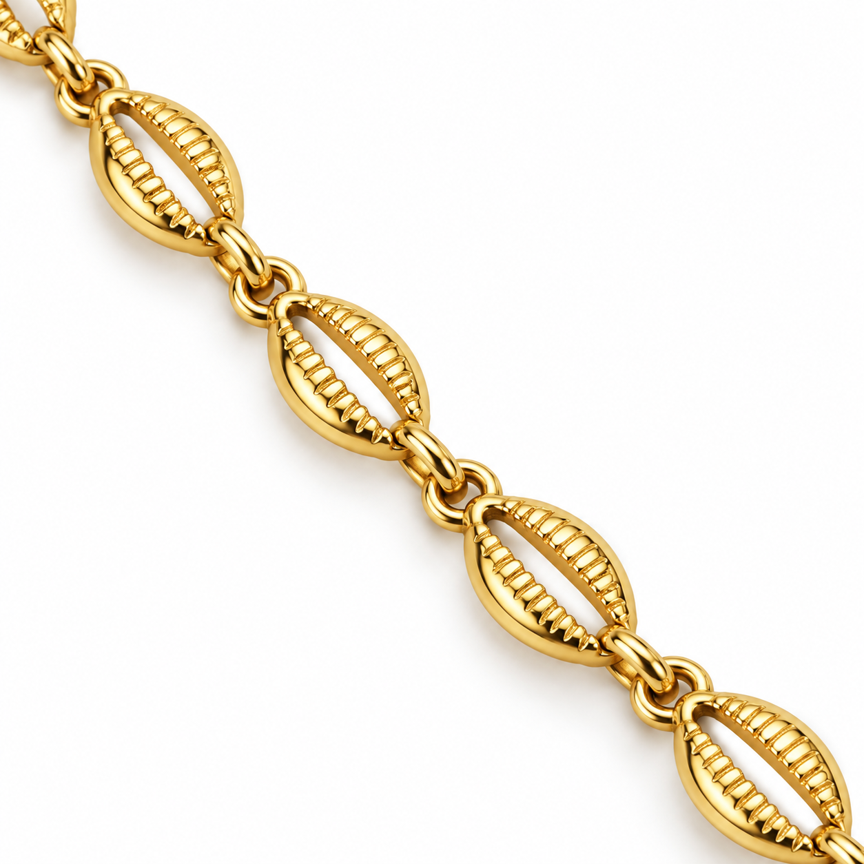 Close-up of the textured cowrie-inspired links and connecting rings of the Tidal Cowrie Y Necklace