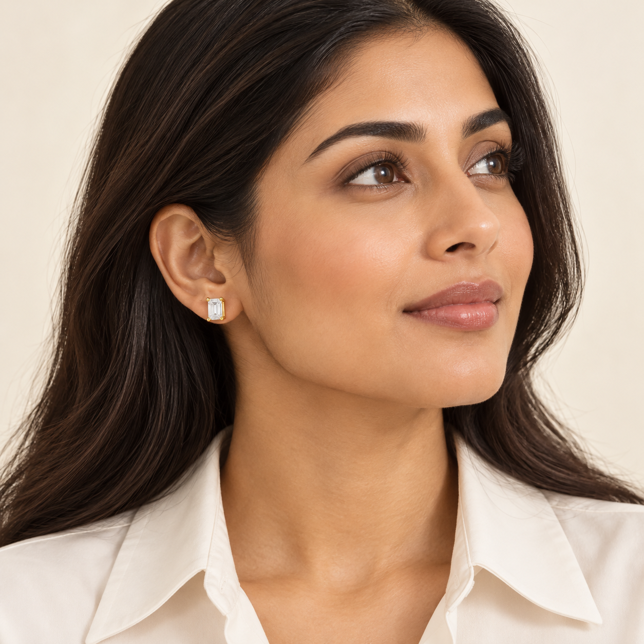 Cadence Emerald-Cut Studs in yellow gold worn on a model, illustrative styling concept