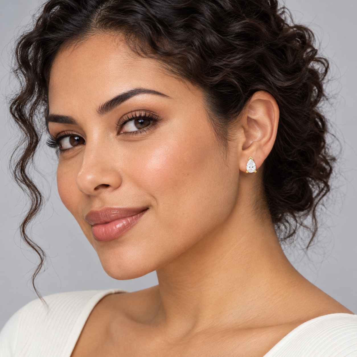 Luma Pear Studs in yellow gold worn on a model, illustrative styling concept