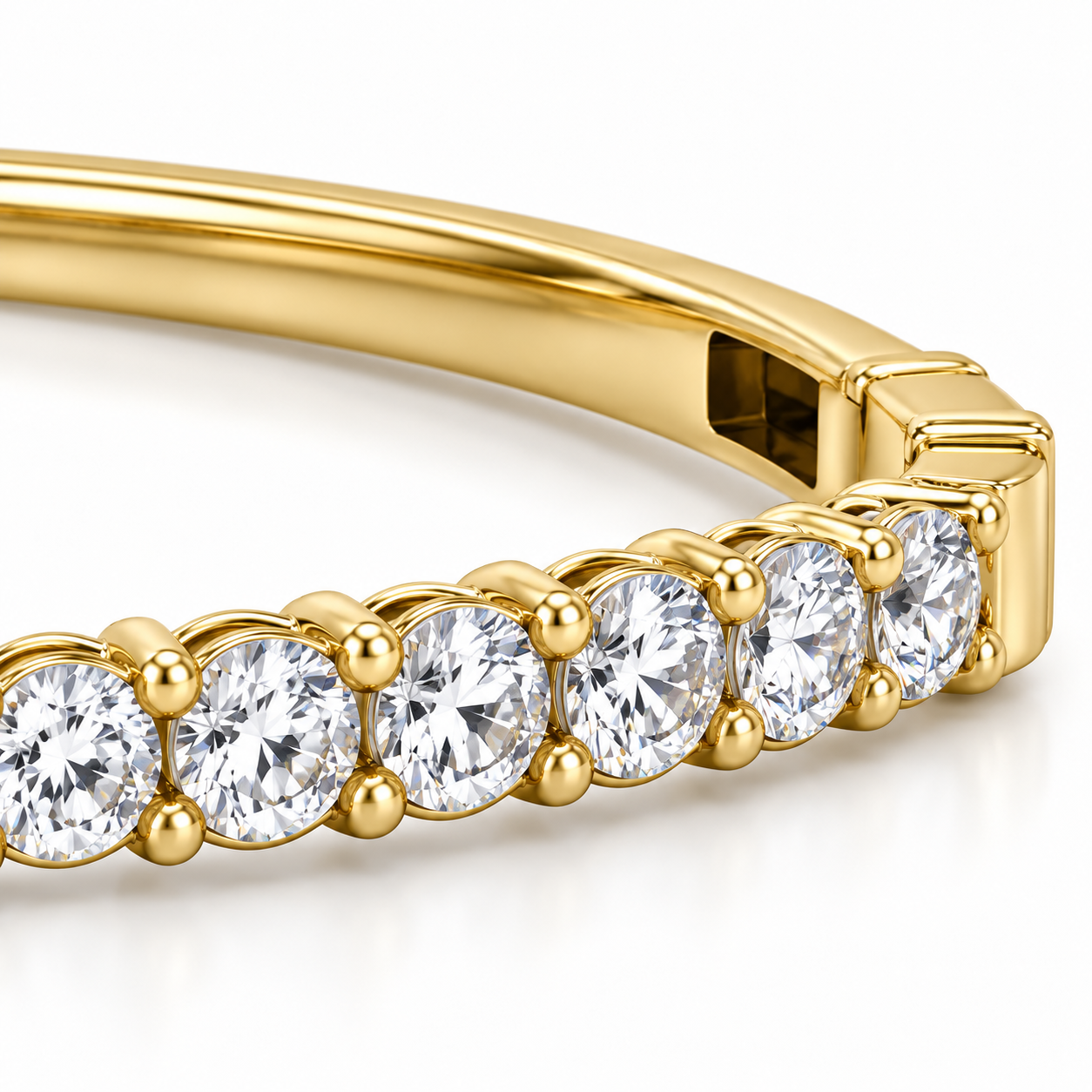Close-up of Lumière Diamond Bangle in yellow gold, showing round stone settings and the closure