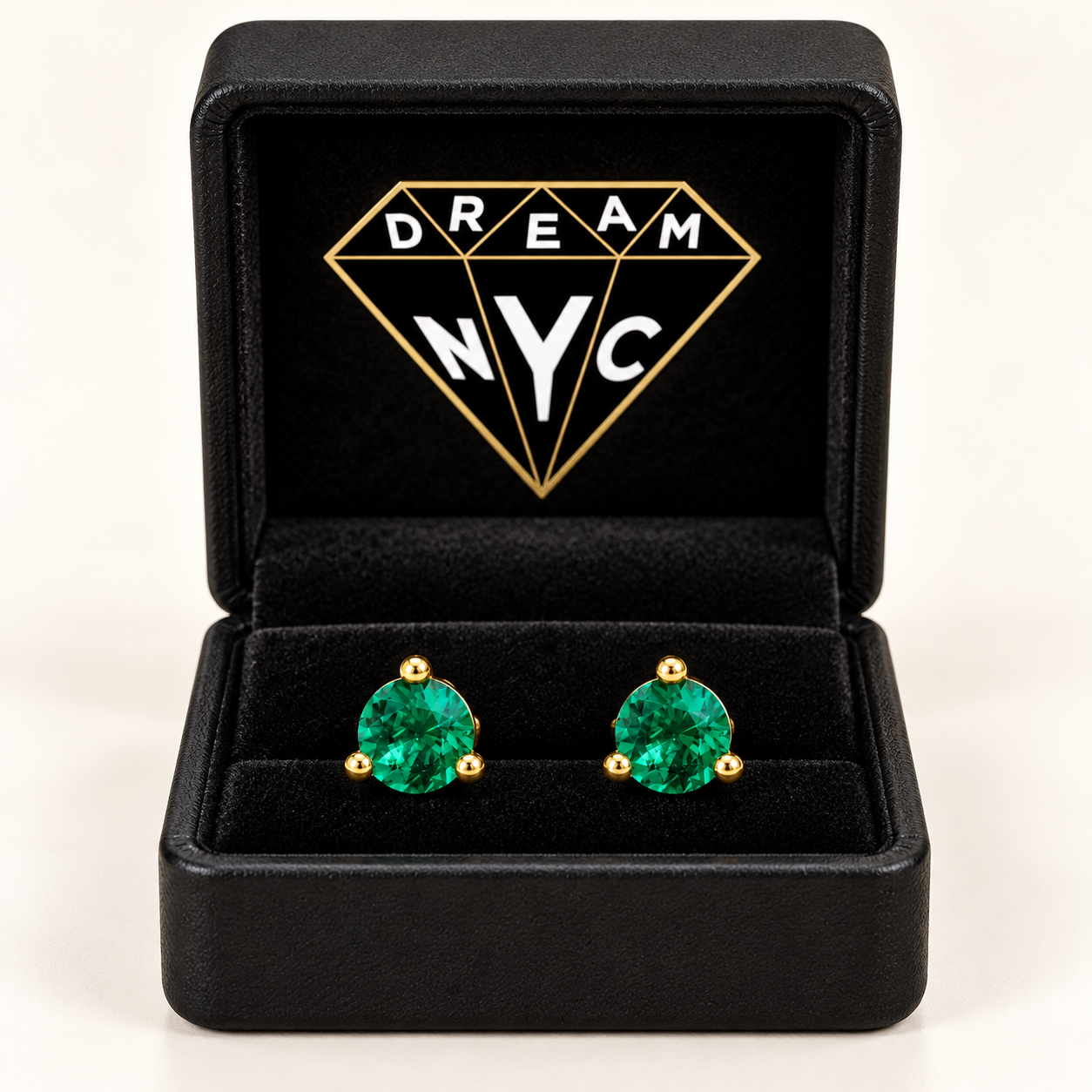 Packaging concept showing Verdant Round green-stone studs in a black DREAM NYC box with the diamond logo inside the lid.