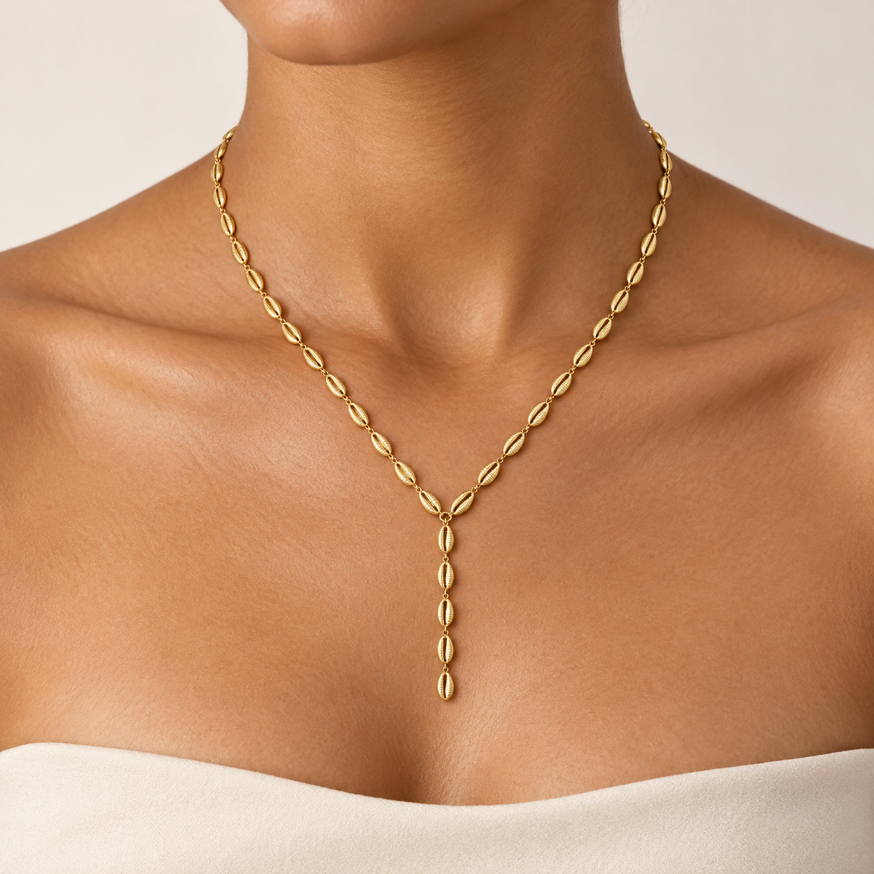 Tidal Cowrie Y Necklace worn on a model, showing the delicate Y shape and five-link drop; styling concept