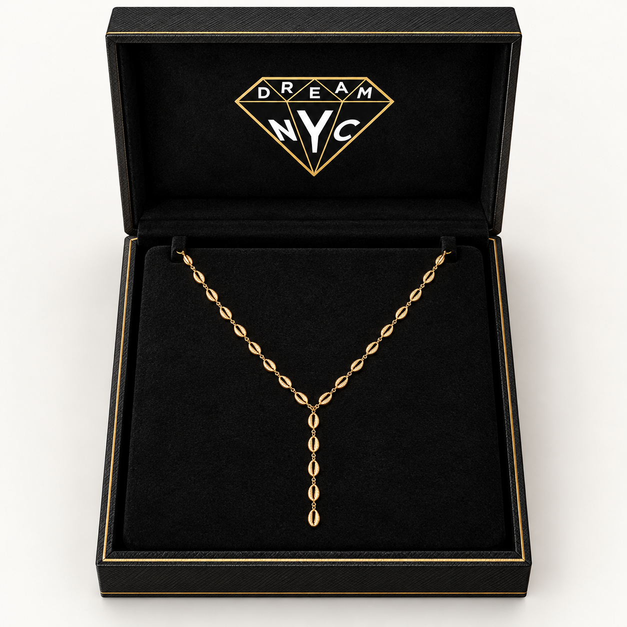 Tidal Cowrie Y Necklace displayed in an open black DREAM NYC necklace box; packaging concept