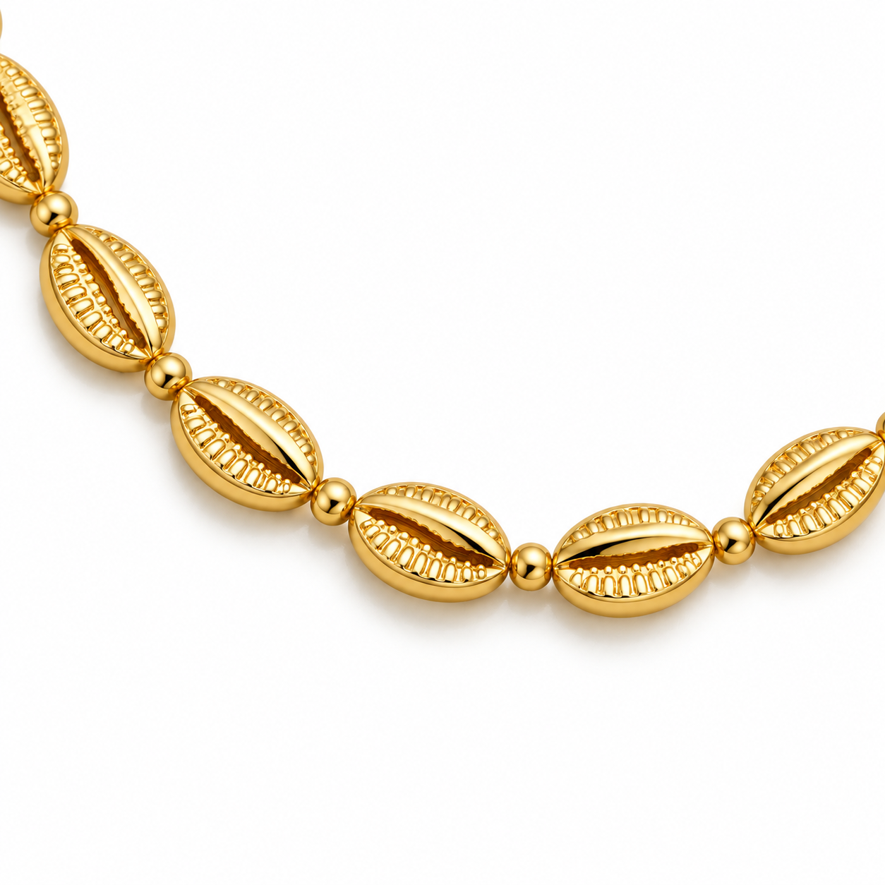 Close-up of Golden Cowrie Necklace showing sculpted cowrie links and small round connectors.